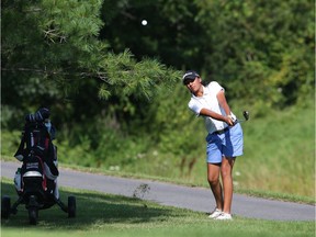 Vaijayanti Bharkhada of Brampton, Ont., plays a recovery shot from the rough on the 18th hole during opening-round play at Camelot on Tuesday. She made a bogey five on that hole and finished with a score of 84. Jean Levac/Postmedia