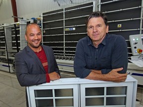 Jimm Fox (R) and Eric Pham-Dihn of Verdun Windows and Doors in front of their new state of the art automated thermal pane assembly line.