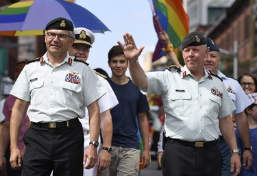 Chief of the Defence Staff Jonathan Vance, centre, marches in the Ottawa Capital Pride parade, the first time a Chief of the Defence Staff has marched in a pride parade, Sunday, Aug. 27, 2017. THE CANADIAN PRESS/Justin Tang ORG XMIT: JDT109