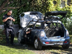 On Letchworth Road Ottawa police look at a burnt our car on Letchworth Road in Ottawa Ontario Monday Aug 28, 2017.