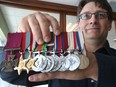 David Currie, grandson of Victoria Cross recipient Lt. Col David V. Currie, poses for a photo with his grandfather's medals.