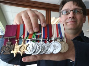 David Currie, grandson of Victoria Cross recipient Lt. Col David V. Currie, poses for a photo with his grandfather's medals in Kemptville Ontario Friday Aug 25, 2017.