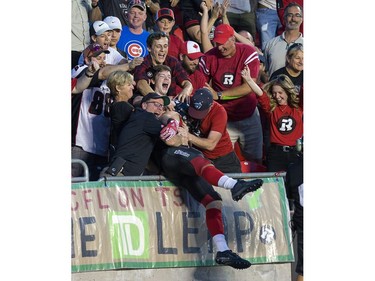 Greg Ellingson is mobbed by fans after his touchdown in the second quarter.   Wayne Cuddington/Postmedia