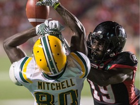 Redblacks defensive back Imoan Claiborne, right, interferes with Eskimos receiver Bryant Mitchell during Thursday's game at TD Place stadium, earning a 36-yard penalty.   Wayne Cuddington/Postmedia