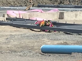 A bouquet of flowers sits at a Gatineau construction site on Thursday, Aug. 10, 2017.