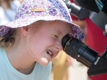 Olivia Siegel, 6, takes a look through a telescope as the partial solar eclipse is observed at an event held by the Royal Astronomical Society at the Canadian Aviation and Space Museum in Ottawa. Photo Wayne Cuddington/ Postmedia
Wayne Cuddington, Postmedia