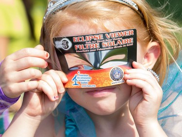 Sage Vaillancourt checks the eclipse as the partial solar eclipse is observed at an event held by the Royal Astronomical Society at the Canadian Aviation and Space Museum in Ottawa. Photo Wayne Cuddington/ Postmedia
Wayne Cuddington, Postmedia