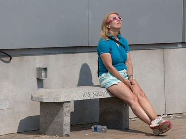 A woman finds a quiet spot as the partial solar eclipse is observed at an event held by the Royal Astronomical Society at the Canadian Aviation and Space Museum in Ottawa. Photo Wayne Cuddington/ Postmedia
Wayne Cuddington, Postmedia