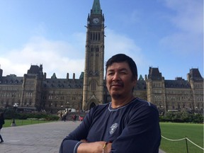 Clarence Neshinapaise stands outside the Parliament Buildings after completing his 1,800-kilometre walk on Friday, Aug. 18, 2017.