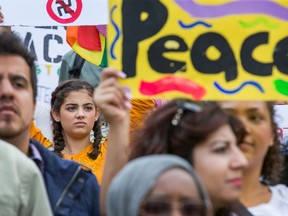 Sadie Laflamme-Snow, 17, (L) joins about 700 demonstrators took part in a noon time anti-racism protest in front of the US embassy in Ottawa. The peaceful demo was to voice their opinions against white supremacy and racism in all its forms.   Photo Wayne Cuddington/ Postmedia
Wayne Cuddington, Postmedia