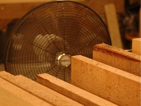 It's surprising how quickly lumber can dry with a fan blowing over it. These 1"-thick fresh-cut white pine boards started off wet enough that water came out when you drove screws in them. Six weeks later they were dry enough for making furniture.