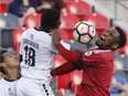 Ottawa Fury FC's Eddie Edward, right, and Harrisburg City Islanders' Abass Mohammed try to head the ball in a game on June 10.