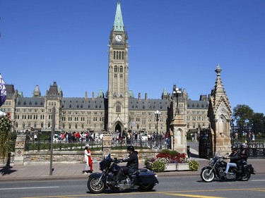 Bikers Against Child Abuse ride past the Parliament Buildings in Ottawa on Saturday, Sept. 3, 2017.