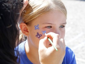Mackenzie, 7, has her face painted at the Teal Tailgate Party before the Ovarian Cancer Walk of Hope in Ottawa on Saturday, September 2, 2017.