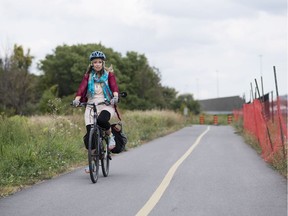 Lynn Hart rides along a bike path near Crystal Beach. She's among those who oppose the city's proposed location of the Moodie Drive LRT station, fearing the station will impact the natural area along Corkstown Road east of Moodie Drive.