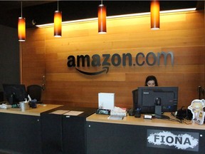 Nikol Szymul staffs a reception desk at Amazon offices in a building called Fiona in downtown Seattle. Amazon is seeking to expand, and Ottawa wants a piece of the action.