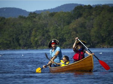 The Ottawa Riverkeeper held Ride the River family parade and picnic Sunday September 10, 2017. Various boats and boards were paddled down a stretch of the Ottawa River to celebrate the body of water that is the newest Canadian Heritage River. From left, Nicolas Moyer, five-year-old Saya Moyer and Sophie Cathelineau were dressed like pirates as they celebrate Nicolas's birthday by paddling down the river.