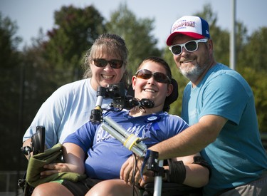 Members of the Ottawa Police Service paired up with the Miracle League of Ottawa and then they duked it out to see who got to take home the Miracle League/Ottawa Police Service Game of Champions trophy in the second annual event at Miracle League Ballpark in Navan on Saturday, Sept. 16, 2017. From left, Michelle Desrochers, birthday boy Bryce Desrochers, 15, and Rolly Desrochers. The ballpark was inspired by Bryce, who just wanted to get out and play ball like other kids, said event organizer Detective Angela Robinson. 'His mother Michelle, and father Rolly worked to make this dream come true for their son.'