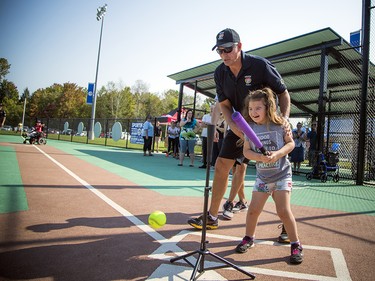 Eight-year-old Ashlyn Piche-Fufton shows off her ball skills with a little help from Ottawa police Inspector Pat Flanagan.