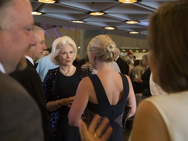 Adrian Burns, chair of the NAC board of trustees, greets guests as they arrive at the NAC Saturday evening.