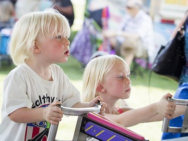 Warm summer weather brought lots of people out to the 173rd Richmond Fair. From left, two-year-old Owen Prue and his big sister, four-year-old Abby, play at a water gun game.