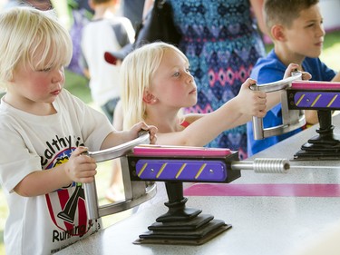 Warm summer weather brought lots of people out to the 173rd Richmond Fair. From left, two-year-old Owen Prue and his big sister, four-year-old Abby, play at a water gun game.