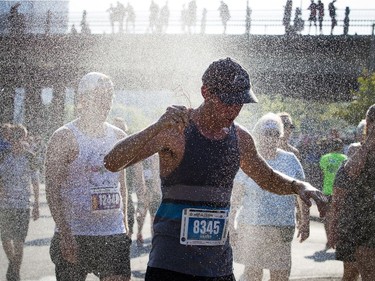 The 10th anniversary of the 2017 Canada Army Run took place Sunday, September 17, 2017 with 5K, 10K and half marathon races. Harry Jurgens cools off under a sprinkler of water after taking part in the Vimy Challenge.
