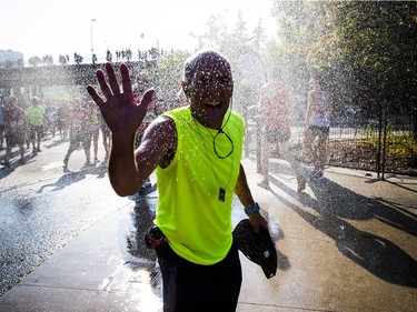 The 10th anniversary of the 2017 Canada Army Run took place Sunday, September 17, 2017 with 5K, 10K and half marathon races. A runner waves as he cools off in the sprinkler after completing his race.