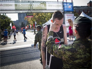 The 10th anniversary of the 2017 Canada Army Run took place Sunday, September 17, 2017 with 5K, 10K and half marathon races. Kyle Wyatt gets his medal after completing the half marathon first.