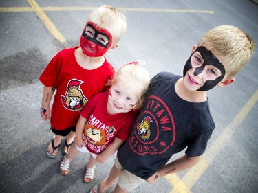 The Ottawa Senators annual Fan Fest took place Sunday, September 17, 2017 at Canadian Tire Centre. These siblings were showing off their Senators spirit with shirts and face paint, L-R five-year-old Eric, three-year-old Brynn and seven-year-old Aiden Murphy.   Ashley Fraser/Postmedia
Ashley Fraser, Postmedia