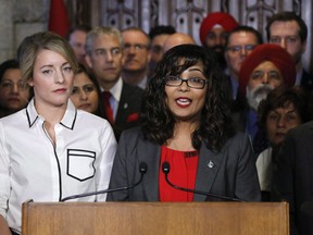 Liberal MP Iqra Khalid makes an announcement about an anti-Islamophobia motion on Parliament Hill while Minister of Canadian Heritage Melanie Joly looks on in Ottawa on Wednesday, February 15, 2017. The MP who touched off a fiery debate across Canada with a motion on Islamophobia, is urging parliamentarians to take a unified approach to find ways to combat it.