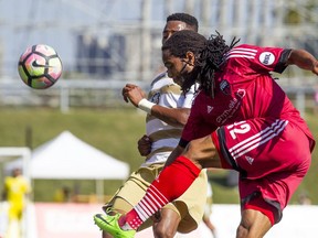 Fury FC's Andrae Campbell attempts a shot at goal despite defensive pressure from Louisville City FC's Mark-Anthony Kaye during Sunday's game at TD Place stadium.   Ashley Fraser/Postmedia