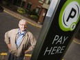 Mike Milinkovich, one of many tenants at Minto buildings upset by the landlord's decision to start charging for visitors parking, photographed by a visitor parking meter at 91 Valley Stream Dr. on Sept. 28, 2017.