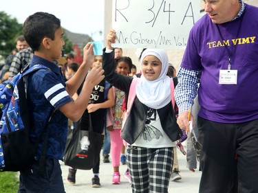 - Mr. Gibson's grade three students seemed thrilled to be in his class, proudly marching in behind him to class. It was the first day back at school for kids in Ottawa's public board Tuesday (Sept. 5, 2017). However, for almost 600 children, it was their first day at a new school, Vimy Ridge Public School, which opened Tuesday in Findlay Creek and held an opening ceremony outside, complete with a flag raising and veteran bagpiper.  Julie Oliver/Postmedia
Julie Oliver, Postmedia