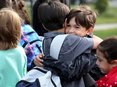- Friends seemed happy to see each other as they lined up for class out in the yard before the bell rang.  It was the first day back at school for kids in Ottawa's public board Tuesday (Sept. 5, 2017). However, for almost 600 children, it was their first day at a new school, Vimy Ridge Public School, which opened Tuesday in Findlay Creek and held an opening ceremony outside, complete with a flag raising and veteran bagpiper.  Julie Oliver/Postmedia
Julie Oliver, Postmedia