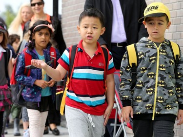 It was the first day back at school for kids in Ottawa's public board Tuesday (Sept. 5, 2017). However, for almost 600 children, it was their first day at a new school, Vimy Ridge Public School, which opened Tuesday in Findlay Creek and held an opening ceremony outside, complete with a flag raising and veteran bagpiper.  Julie Oliver/Postmedia
Julie Oliver, Postmedia