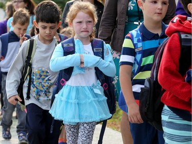 First days can be hard at any age and it all seemed a bit much for one grade three girl, who got upset when she found herself in the wrong lineup heading into school.  It was the first day back at school for kids in Ottawa's public board Tuesday (Sept. 5, 2017). However, for almost 600 children, it was their first day at a new school, Vimy Ridge Public School, which opened Tuesday in Findlay Creek and held an opening ceremony outside, complete with a flag raising and veteran bagpiper.  Julie Oliver/Postmedia
Julie Oliver, Postmedia