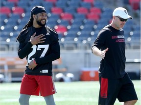 Redblacks defensive back Sherrod Baltimore, left, gets a laugh from head coach Rick Campbell  during practice on Wednesday. Julie Oliver/Postmedia