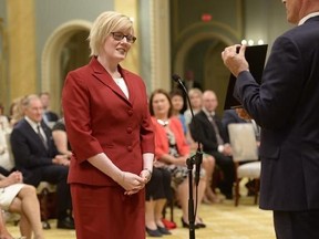 Carla Qualtrough is sworn in as Minister of Public Works and Procurement during a ceremony at Rideau Hall in Ottawa on Monday, Aug. 28, 2017. After being the minister of sport and persons with disabilities - a natural fit for a legally blind human rights lawyer who won three medals for swimming at the 1988 Seoul and 1992 Barcelona Paralympic Games - Qualtrough, 45, has taken on a bigger role, this time as minister for public services and procurement. THE CANADIAN PRESS/Adrian Wyld