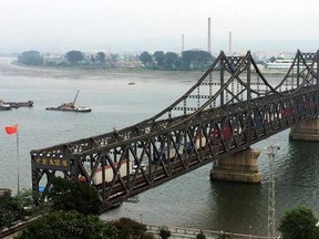 FILE - In this Monday, Sept. 4, 2017, file photo, trucks crosses the friendship bridge connecting China and North Korea in the Chinese border town of Dandong, opposite side of the North Korean town of Sinuiju. China has long been the North‚Äôs main trading partner and diplomatic protector. But Kim Jong Un‚Äôs nuclear and missile tests have alienated Chinese leaders, who supported last month‚Äôs U.N. sanctions that slash North Korean revenue by banning sales of coal and iron ore. Beijing tried to