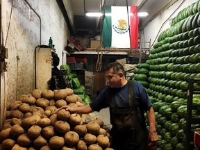 Jorge Guzman tends to his stall in Mexico City&#039;s Central de Abasto, claimed to be the world&#039;s largest outdoor market with 500,000 daily visitors, on Monday, Sept. 4, 2017. Central de Abasto&#039;s inhabitants carry a diversity of opinions on the burning economic question of the moment: what to do with NAFTA. Free trade has created winners and losers here. THE CANADIAN PRESS/Alex Panetta