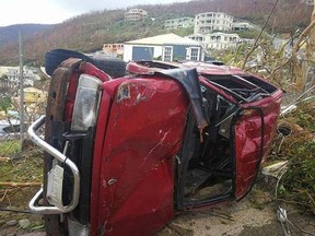 CORRECTS DATE - This Thursday, Sept. 7, 2017 photo shows a damaged vehicle flipped on its side in the aftermath of Hurricane Irma in Tortola, in the British Virgin Islands. Irma scraped Cuba&#039;s northern coast Friday on a course toward Florida, leaving in its wake a ravaged string of Caribbean resort islands strewn with splintered lumber, corrugated metal and broken concrete. (Jalon Manson Shortte via AP)