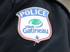 GATINEAU, QC: JANUARY 6, 2014 -- Gatineau police guard the scene of an apparent double homicide at 158 Terrasse Eardley in the Aylmer sector of Gatineau, Quebec on Monday, January 6, 2014. The body of a man and woman were found inside a row house this afternoon after a 9-1-1 call. A child was also found inside, but not injured. (photo by Mike Carroccetto / Ottawa Citizen)¤¤ (for WEB / CITY story by SHAAMINI) NEG# 115693