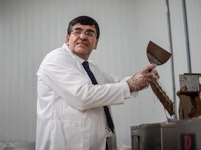 Syrian chocolatier Assam Hadhad puts chocolate into moulds at his newly opened Peace By Chocolate factory in Antigonish, N.S. on Saturday, September 9, 2017. THE CANADIAN PRESS/Darren Calabrese