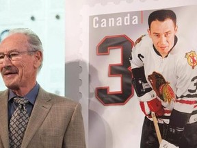 Pierre Pilote smiles beside his stamp during the unveiling of the NHL stamp series featuring the Original Six Defencemen at the Hockey Hall of Fame in Toronto on Thursday, Oct. 2, 2014. Former Blackhawks defenceman Pilote, who won a Stanley Cup with Chicago in 1961, has died. He was 85. The Blackhawks said in a statement Sunday that Pilote had died Saturday night.