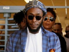 In this March 24, 2016 file photo, American actor and musician Yasiin Bey, also known as Mos Def, leaves the Bellville Magistrates&#039; Court in Bellville, South Africa. Bey took the stage at the ONE Musicfest, a one-day music festival held in Atlanta, for what appeared to be the last performance of his career.