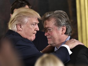 (FILES) This file photo taken on January 22, 2017 shows US President Donald Trump (L) congratulating Senior Counselor to the President Stephen Bannon during the swearing-in of senior staff in the East Room of the White House on January 22, 2017 in Washington, DC. Steve Bannon, President Donald Trump's chief strategist, has lost his seat on the powerful National Security Council on April 05, 2017 in an apparent high-level shakeup, a US official confirmed.  / AFP PHOTO / MANDEL NGANMANDEL NGAN/AFP/Getty Images