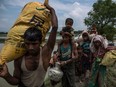 Rohingya Muslim refugees make their way into Bangladesh after crossing the Myanmar Bangladesh border on September 07, 2017 in Whaikhyang Bangladesh. Thousands of Rohingya continue to cross the border after violence erupted in Myanmar's Rakhine state when the country's security forces allegedly launched an operation against the Rohingya Muslim community.