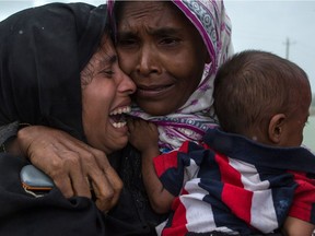 Rohingya Muslim refugees react after being re-united with each other after arriving on a boat from Myanmar on Sept. 08,in Whaikhyang Bangladesh. Thousands of Rohingya continue to cross the border after violence erupted in Myanmar's Rakhine state when the country's security forces allegedly launched an operation against the Rohingya Muslim community.