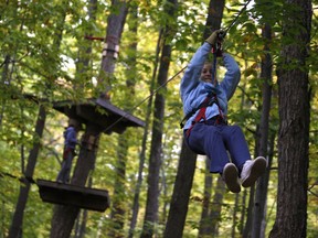 Julia Boyle zip-lines at Camp Fortune Aerial Experience. Photo by David Kawai/ Postmedia.